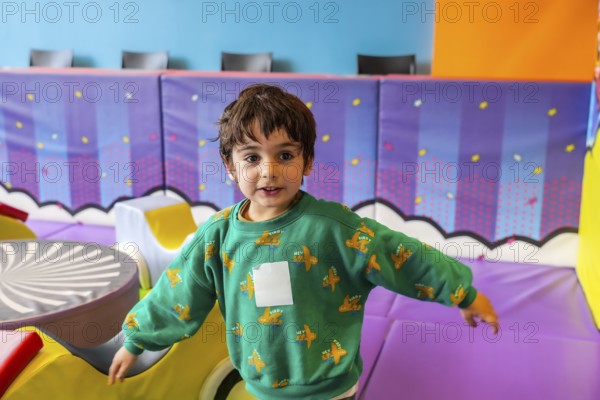 Preschooler enjoying playtime in a vibrant and stimulating indoor play area, promoting early childhood development and fun