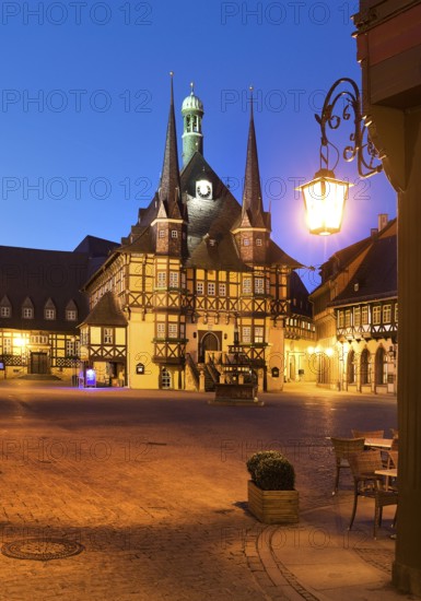 Market square with atmospherically illuminated town hall in the evening, Wernigerode, Harz, Saxony-Anhalt, Germany, Europe