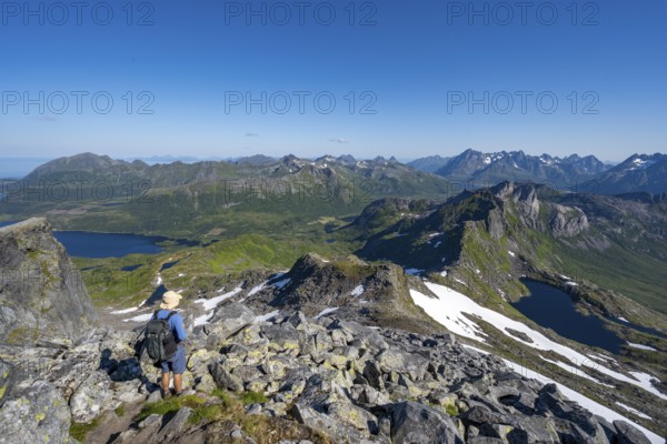 View of mountains and fjord landscape, mountain panorama, mountaineer at the summit of Rundfjellet, lake Hellskarvatnet, Svolvaer, Nordland, Norway, Europe