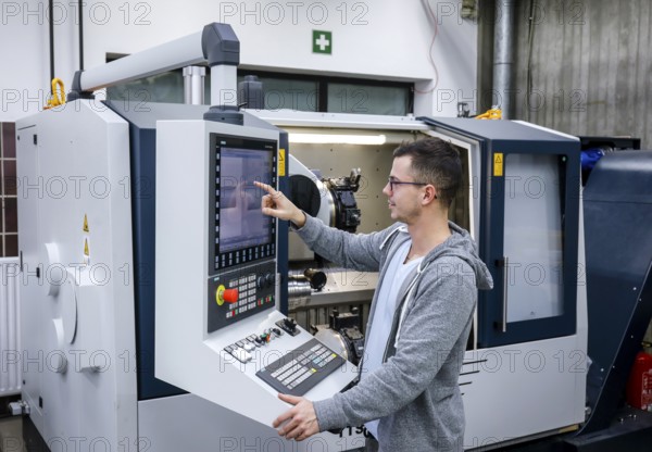 Remscheid, North Rhine-Westphalia, Germany - Trainee in metalworking, here at a CNC machine tool, Vocational Training Centre of the Remscheid metal and electrical industry. - FOR EDITORIAL USE ONLY!