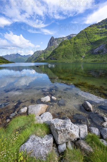 Small boats at the fjord Austnesfjorden, idyllic Norwegian fjord landscape, mountains reflected in the water, Sildpollen, Nordland, Norway, Europe