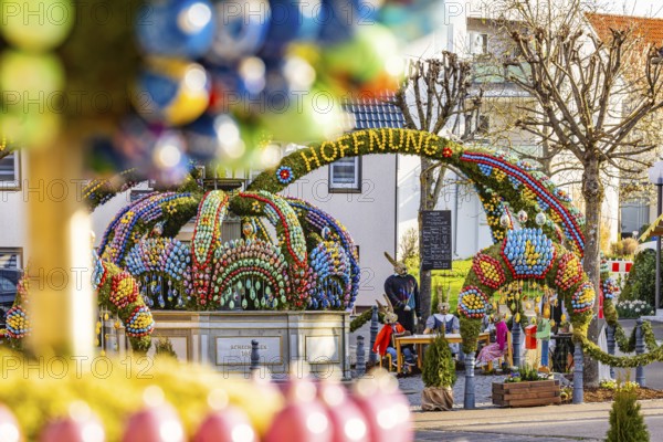 The Easter fountain in Schechingen has around 13, 000 hand-painted eggs. This makes it one of the largest and most beautiful in the whole of East Württemberg. Around 50, 000 visitors admire the decorated village fountain every year. Schechingen, Ostalbkreis, Baden-Württemberg, Germany, Europe