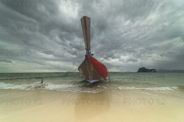 Longtail boat on the beach, dark rain clouds behind, Koh Ngai Island, Andaman Sea, Satun Province, Southern Thailand, Thailand, Asia