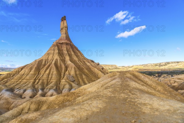 Majestic castildetierra rock formation rising from eroded hills in the bardenas reales desert under a vibrant blue sky