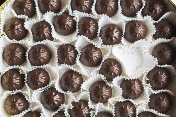Top view and close-up of opened chocolate box with one chocolate missing or eaten, Studio Composition, Quebec, Canada, North America