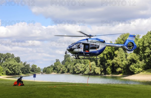 Airbus H 145 police helicopter during an operational exercise with BAMBI BUCKET extinguishing water tank, Düsseldorf, North Rhine-Westphalia, Germany, Europe