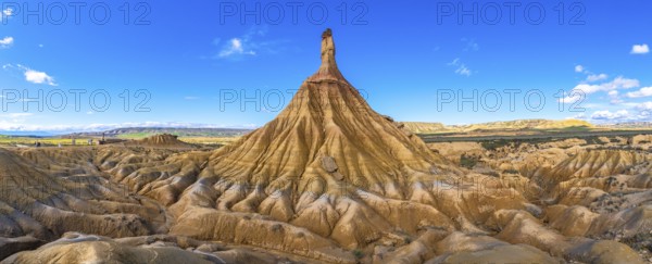 Eroded rock formations creating a breathtaking panorama in the bardenas reales desert under a vibrant blue sky