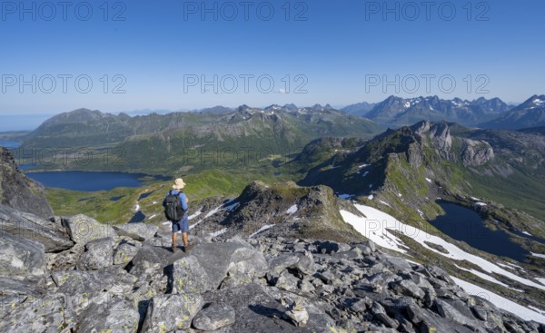 View of mountains and fjord landscape, mountain panorama, mountaineer at the summit of Rundfjellet, lake Hellskarvatnet, Svolvaer, Nordland, Norway, Europe
