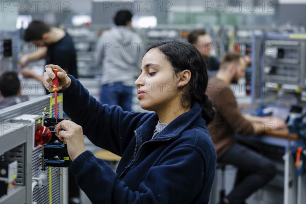 Remscheid, North Rhine-Westphalia, Germany - Trainee woman in electrical professions, an industrial electrician assembles a circuit, Vocational Training Centre of the Remscheid Metal and Electrical Industry. - FOR EDITORIAL USE ONLY!