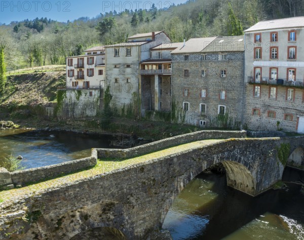 Olliergues village. Old bridge on river Dore. Natural regional park of Livradois Forez. Puy de Dome. Auvergne Rhone Alpes. France