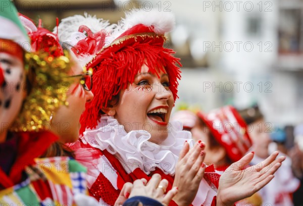 Colourfully costumed carnivalists celebrate carnival in Cologne, on Weiberfastnacht the street carnival is traditionally opened on the Alter Markt, which then reaches its climax on Rosenmontag, Cologne, Rhineland, North Rhine-Westphalia, Germany, Europe