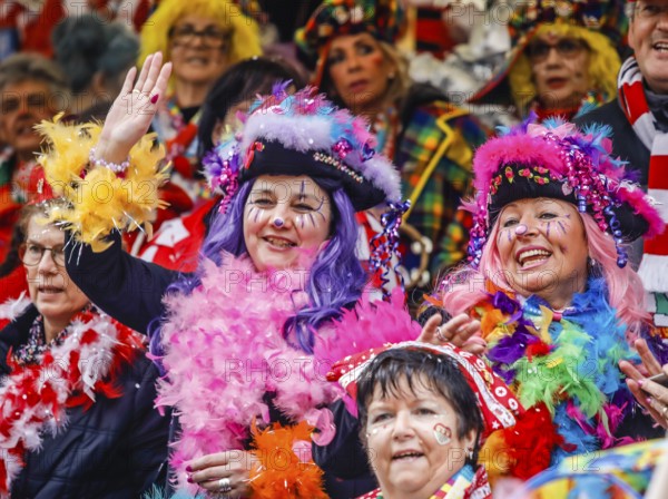 Colourfully costumed carnivalists celebrate carnival in Cologne, on Weiberfastnacht the street carnival is traditionally opened on the Alter Markt, which then reaches its climax on Rosenmontag, Cologne, Rhineland, North Rhine-Westphalia, Germany, Europe