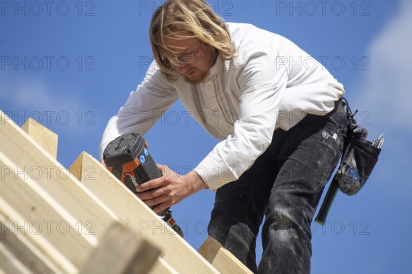 Carpenters working on the roof of a new building in the Rhein-Pfalz district