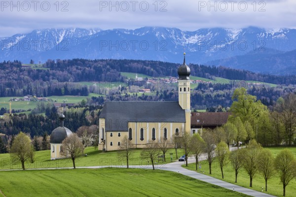 Pilgrimage church Wilparting St. Marinus, mountain landscape, meadow, trees, road, snow-covered mountains, cloudy, nimbostratus clouds, sunlight, light and shadow, haze, Irschenberg, district of Miesbach, Bavaria, Germany, Europe
