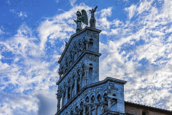 Facade of the church of San Michele in Foro, above the large bronze statue of the Archangel Michael, historic city centre, Lucca, Tuscany, Italy, Europe