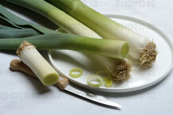 Leek, leek sticks on plate with knife, leek