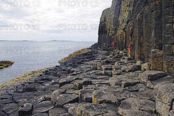 Majestic rock formation with basalt columns on a rugged coastline by the sea, Staffa, Hebrides, Scotland, United Kingdom, Europe