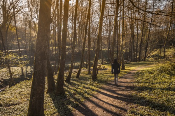 A young woman walking through the natural park of the town of Pasaia Antxo, Basque Country