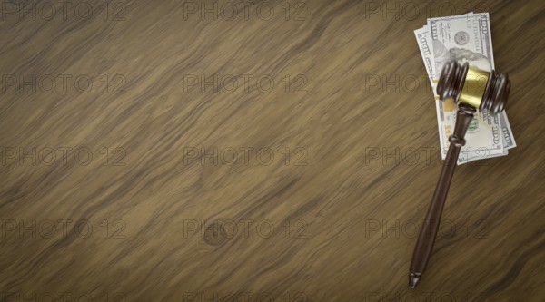 Overhead of gavel resting on a table and stacks of thousands of dollars with room for text