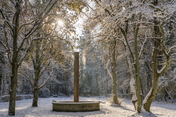 Fountain and snow-covered trees in the sunlight, south-west churchyard, historic cemetery in Stahnsdorf, Potsdam-Mittelmark, Brandenburg, Germany, Europe