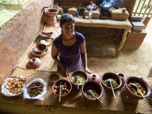 Sinhala woman prepares lunch in clay pots, Sri Lanka, Asia