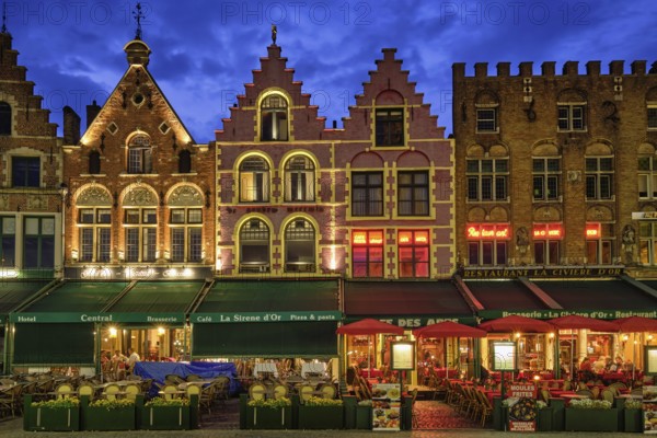 Bruges, Belgium, May 29, 2018: Bruges Grote markt square famous tourist place with many cafe and restaurants in the evening night twilight, Europe
