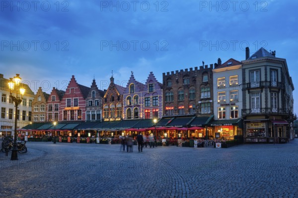 Bruges, Belgium, May 29, 2018: Bruges Grote markt square famous tourist place with many cafe and restaurants in the evening night twilight, Europe