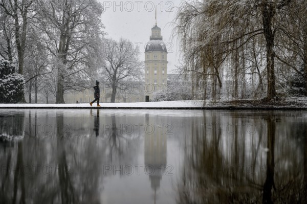 Karlsruhe castle reflected in a pond in the castle garden, Karlsruhe, Baden-Württemberg, Germany, Europe