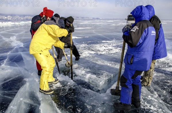 Digging a hole in the ice for scuba diving, Lake Baikal, Olkhon Island, Pribaikalsky National Park, Irkutsk Province, Siberia, Russia, Europe