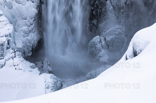 Dettifoss waterfall with icy and snow-covered rock face, Northern Iceland Eyestra, Iceland, Europe
