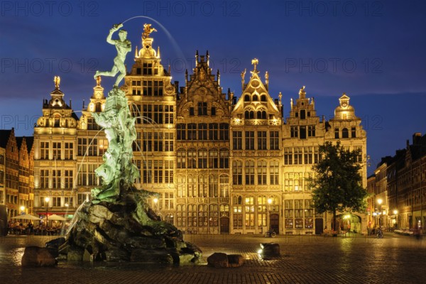 Antwerp famous Brabo statue and fountain on Grote Markt square illuminated at night and old houses. Antwerp, Belgium, Europe