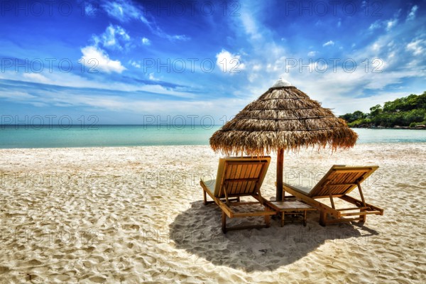 Vacation holidays background wallpaper, two beach lounge chairs under tent on beach. Sihanoukville, Cambodia, Asia