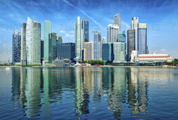 Modern Singapore city skyline of business district downtown in day with reflection in water