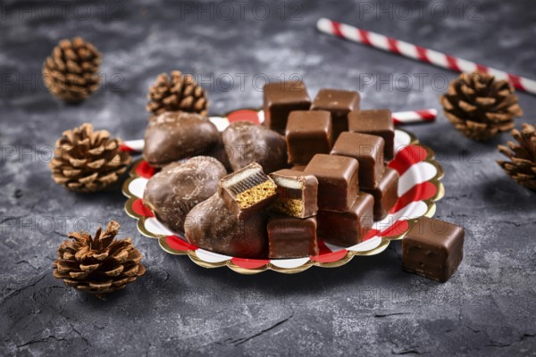 German traditional sweets called Dominosteine, food sold around Christmas season consisting of gingerbread, jelly and marzipan layers covered with chocolate icing and gingerbread hearts