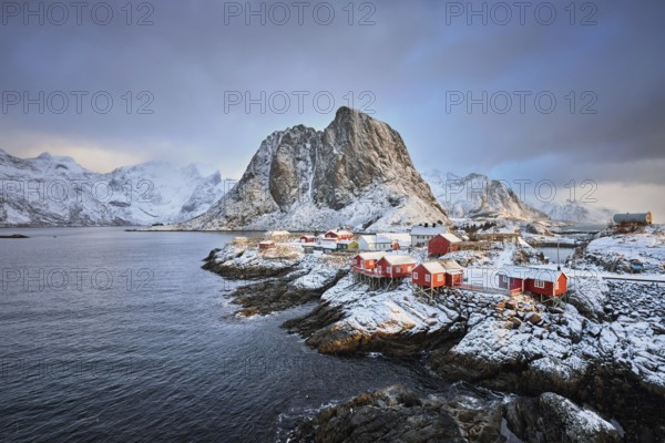 Famous tourist attraction Hamnoy fishing village on Lofoten Islands, Norway with red rorbu houses in winter