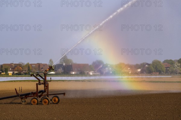 Artificial irrigation of a field, freshly sown, in April, with a sprinkler system, long dry spell in spring makes this necessary for the young plants to grow well, near Kerken, Lower Rhine, North Rhine-Westphalia, Germany, Europe