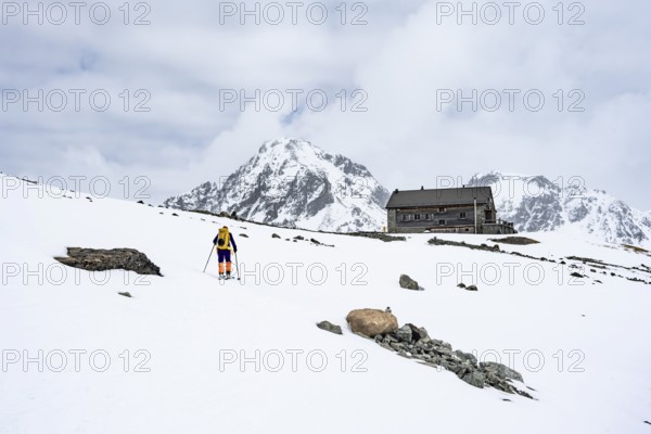 Ski tourer in the mountains in winter, Piz Bever, Chamanna Jenatsch CAS, Swiss Alpine Club hut, Val Beve, Graubünden, Switzerland, Europe