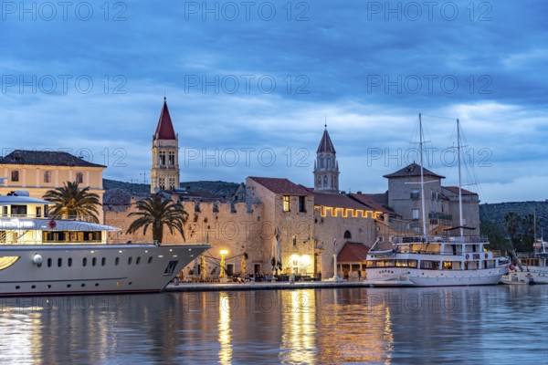 Cruise ships in front of the old town centre of Trogir at dusk, Croatia, Europe