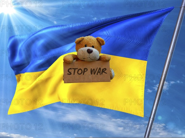 Symbolic picture, Ukraine flag in front of a bright sky, sad little bear with Stop War sign, Donald Trump wanted dictator, Republicans, Russia war against Ukraine, global danger, lies, 2nd term, global burden, questionable USA deal with Russia, scandal in the White House against President Volodymyr Selenskyj in front of running cameras