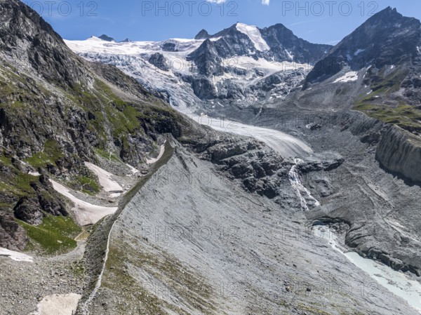 View to mountain hut Cabane de Moiry, located close to the retreating Moiry glacier, hiking trail on glacial moraine, aerial view, Valais, Switzerland, Europe