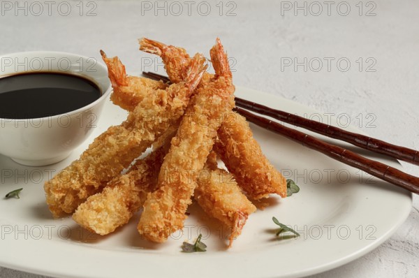 Fried shrimp, peeled in tempura, soy sauce, close-up