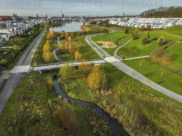 Dortmund, North Rhine-Westphalia, Germany, Phoenix Lake, front of the renaturalised Emscher. The river has been transformed into a near-natural body of water, flood protection and biodiversity through newly designed floodplains. A former industrial wasteland of 99 hectares was transformed into residential, work and leisure areas and 24 hectares of lake surface. In the event of heavy rainfall, the lake acts as a rainwater retention basin. Following the construction of a parallel sewer, the Emscher is now free of wastewater, having previously been an open, above-ground wastewater sewer, combined sewer with surface water and wastewater. The Phoenix Lake, a showcase project for structural change, is an artificial lake on the site of the former Phönix Ost steelworks in Dortmund's Hörde district, Europe