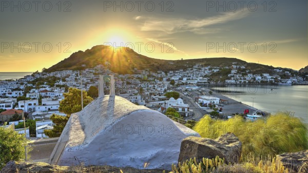 Agia Paraskevi Chapel, Small chapel at sunset with a view of a coastal town and the sea in the background, Skala, Patmos, Dodecanese, Greek Islands, Greece, Europe