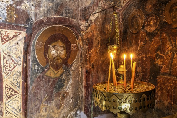 Candlelit orthodox wall painting in a dark, mystical setting, icon depicting Christ, church of Agia Anna, Lefka Ori, White Mountains, mountain massif, west, Crete, Greece, Europe