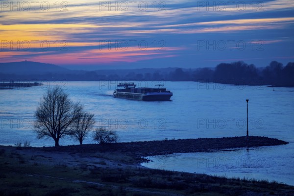 Rhine at Duisburg-Bruckhausen, towers of the water extraction facilities of ThyssenKrupp Steel steelworks, cargo ship, winter, Duisburg, North Rhine-Westphalia, Germany, Europe