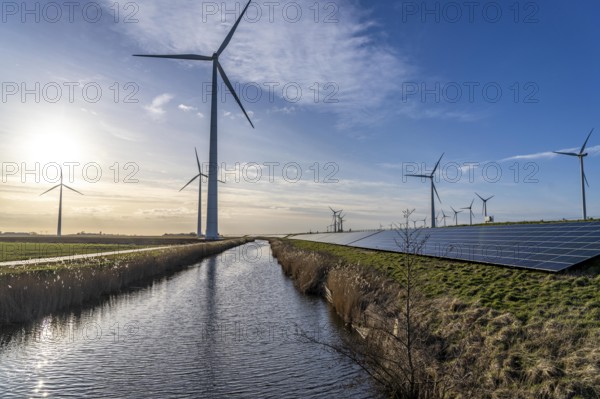 Solar park on the Slaperdijk dyke near the Eemshaven, test project, 17, 000 solar modules were installed over a good 5 kilometres, the Netherlands has over 22, 000 kilometres of dyke line, here it is being tested whether such an installation is successful and can be expanded, wind farm, Groningen, Netherlands