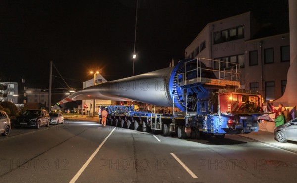 Transport of a 68 metre long, 22 tonne blade of a wind turbine, here in Schwelm, with a self-propelled Blade-Lifter vehicle, over a 40 km long route, over 2 nights, in the Bergisches Land, through towns, villages, over country roads, narrow through roads, to the construction site of the wind turbine near Hagen, North Rhine-Westphalia, Germany, Europe