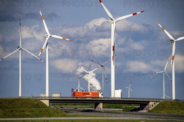 RWE Windpark Jüchen A44n, Garzweiler wind farm, at the Garzweiler opencast lignite mine, on the A44 motorway, Jackerath motorway junction, including Nordex N149 wind turbines, located on recultivated areas of the opencast lignite mine, in the background the RWE Power Neurath coal-fired power station, North Rhine-Westphalia, Germany, Europe