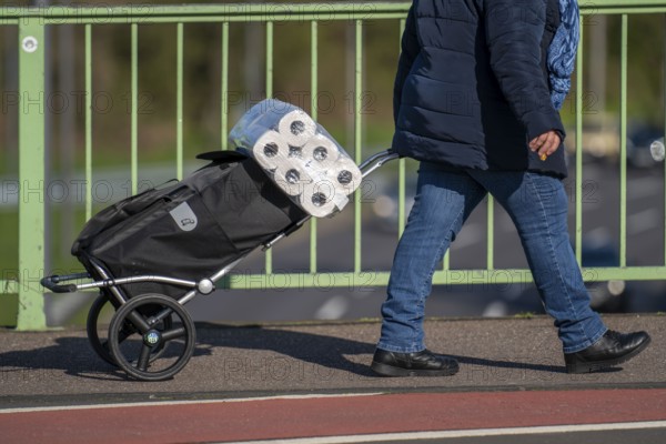 Effects of the coronavirus crisis, woman bought a large pack of toilet paper, Cologne, Germany, Europe