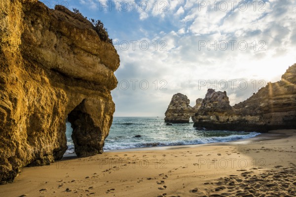 Rocky coast with beach and red rocks, Praia do Camilo, Lagos, Algarve, Portugal, Europe